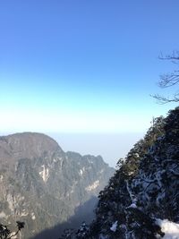 Scenic view of mountains against clear blue sky