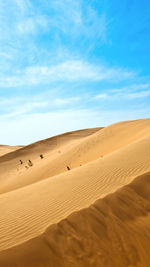 Scenic view of desert against blue sky