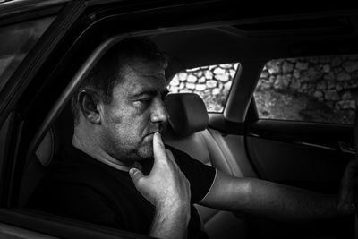 Portrait of man sitting in car