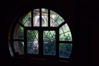 Silhouette building seen through glass window