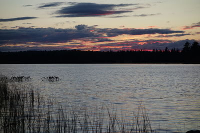 Scenic view of lake against sky during sunset