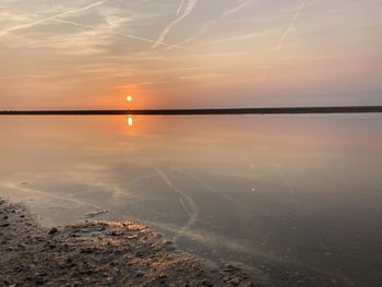 Scenic view of lake against sky during sunset