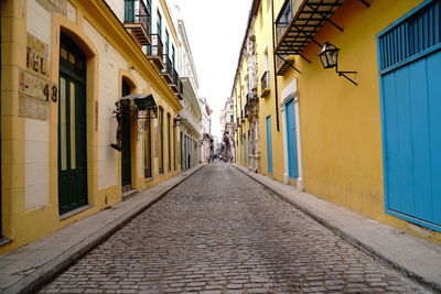 Empty alley amidst buildings in city