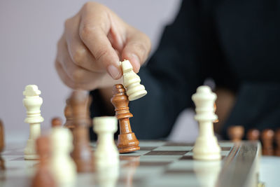 Low angle view of man playing on chess board