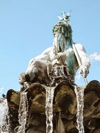 Low angle view of statue against blue sky