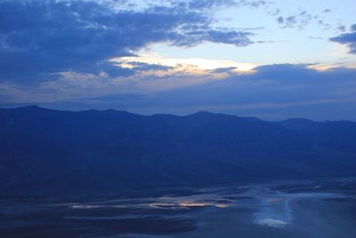 Scenic view of mountains against cloudy sky