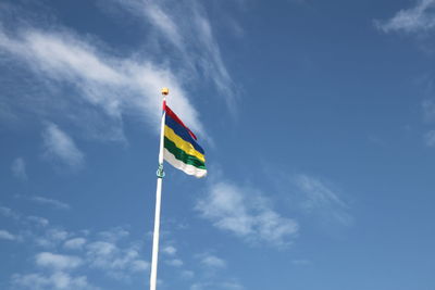 Low angle view of colorful flag against sky