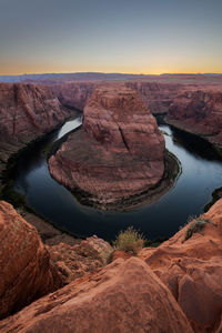 High angle view of horseshoe bend against sky during sunset