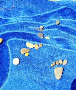 Close-up of pebbles on sand