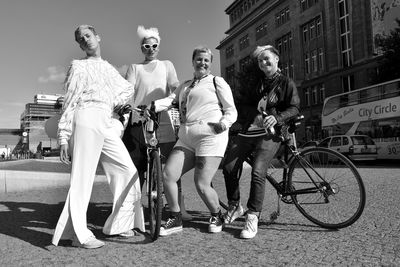 People riding bicycle on road in city