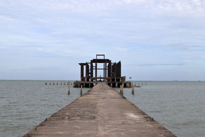 Pier over sea against sky