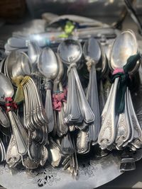 High angle view of spoons in plate on table