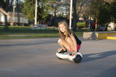 Portrait of girl riding hoverboard