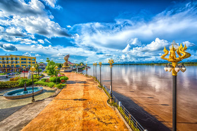 View of bridge over river against cloudy sky