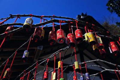 Low angle view of decorations hanging against sky