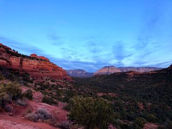 Scenic view of mountains against blue sky