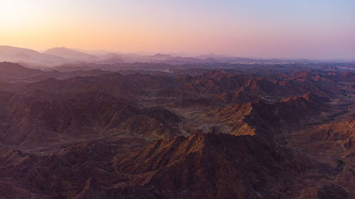 Aerial view of dramatic landscape during sunset
