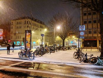 People on illuminated street at night