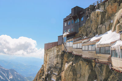 Buildings on rocky mountains at aiguille de midi