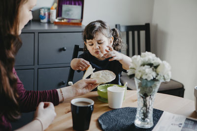 Mother with daughter at table