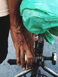 Close-up of hand holding cigarette