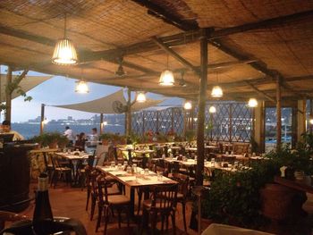 Table and chairs in restaurant at night