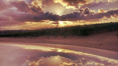 Scenic view of landscape against cloudy sky