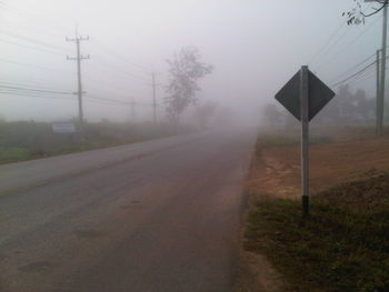 Road passing through foggy weather