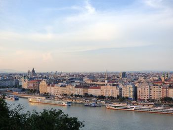 High angle view of river by buildings in city against sky