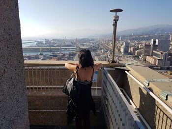 Rear view of woman looking at city buildings