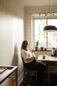 Woman sitting on chair at home