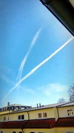 Low angle view of vapor trails against sky