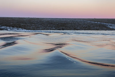 Scenic view of sea against clear sky during sunset