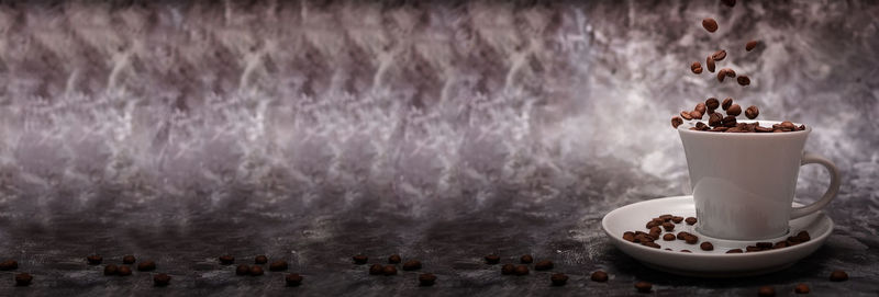 Close-up of coffee on table against wall