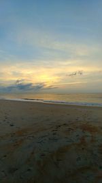 Scenic view of beach against sky during sunset