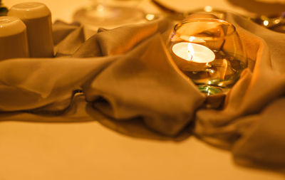 Close-up of illuminated lighting equipment on table