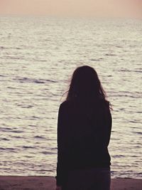 Rear view of man looking at sea