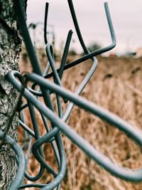 Close-up of bicycle on metal fence