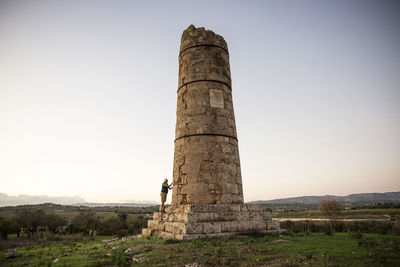 Italy, sicily, helorus, senior man standing at a column of a hellenistic tomb