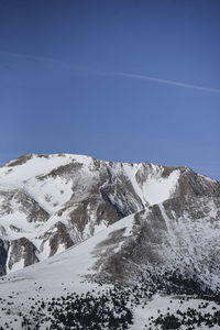 Scenic view of snowcapped mountains against clear blue sky