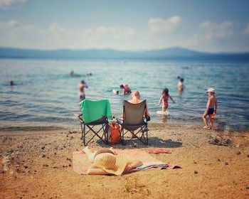 People on beach against sky