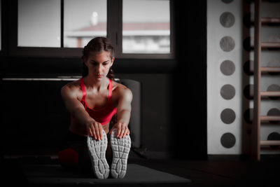 Young woman exercising in gym