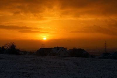 Scenic view of snow field against sky during sunset