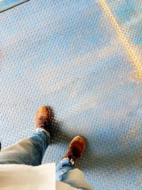 Low section of man standing on floor