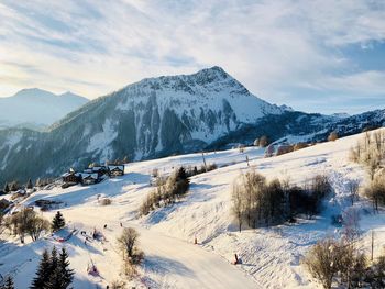 Scenic view of snow covered mountains against sky