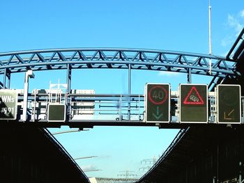 Low angle view of bridge against blue sky