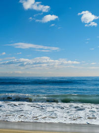 Scenic view of sea against blue sky