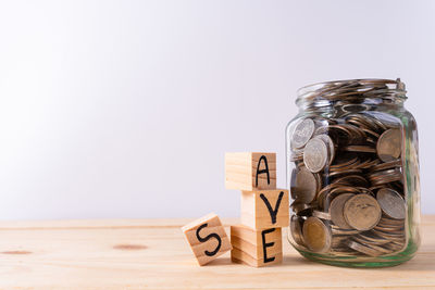 Close-up of coins on table against white background