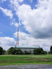 View of tower on field against cloudy sky