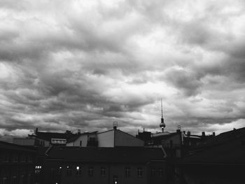 Buildings against cloudy sky